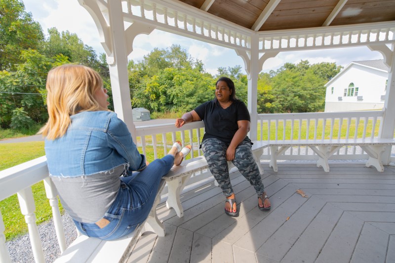 Two patients speak while relaxing in a gazebo at White Deer Run of Allenwood